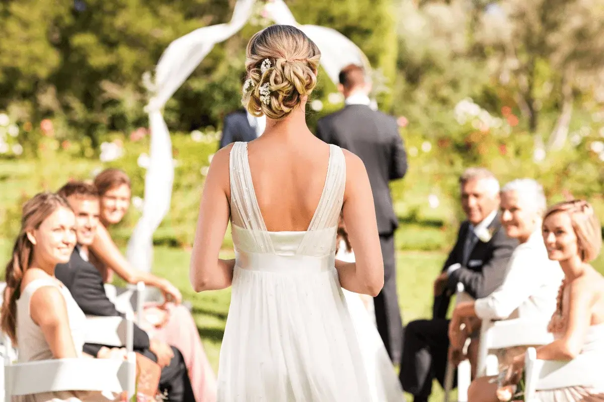 Wedding ceremony aisle in The Garden Room, guests seated on either side