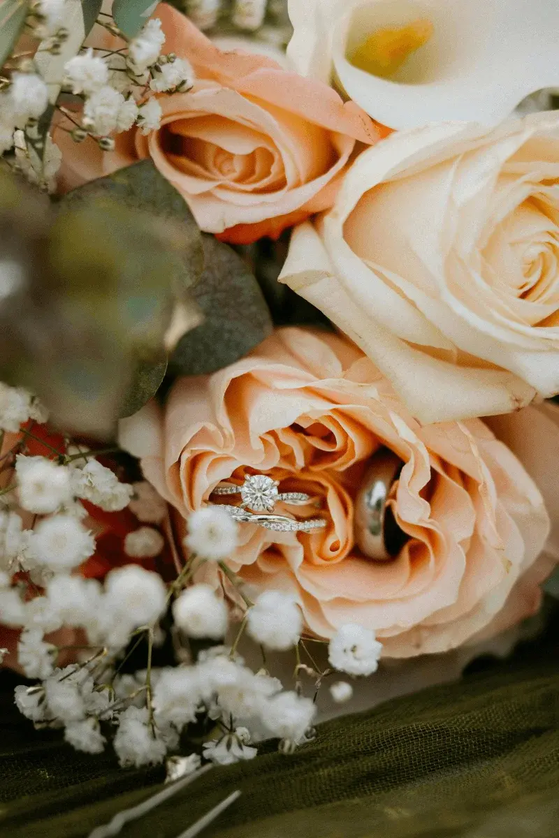 Wedding rings resting on a bed of petals