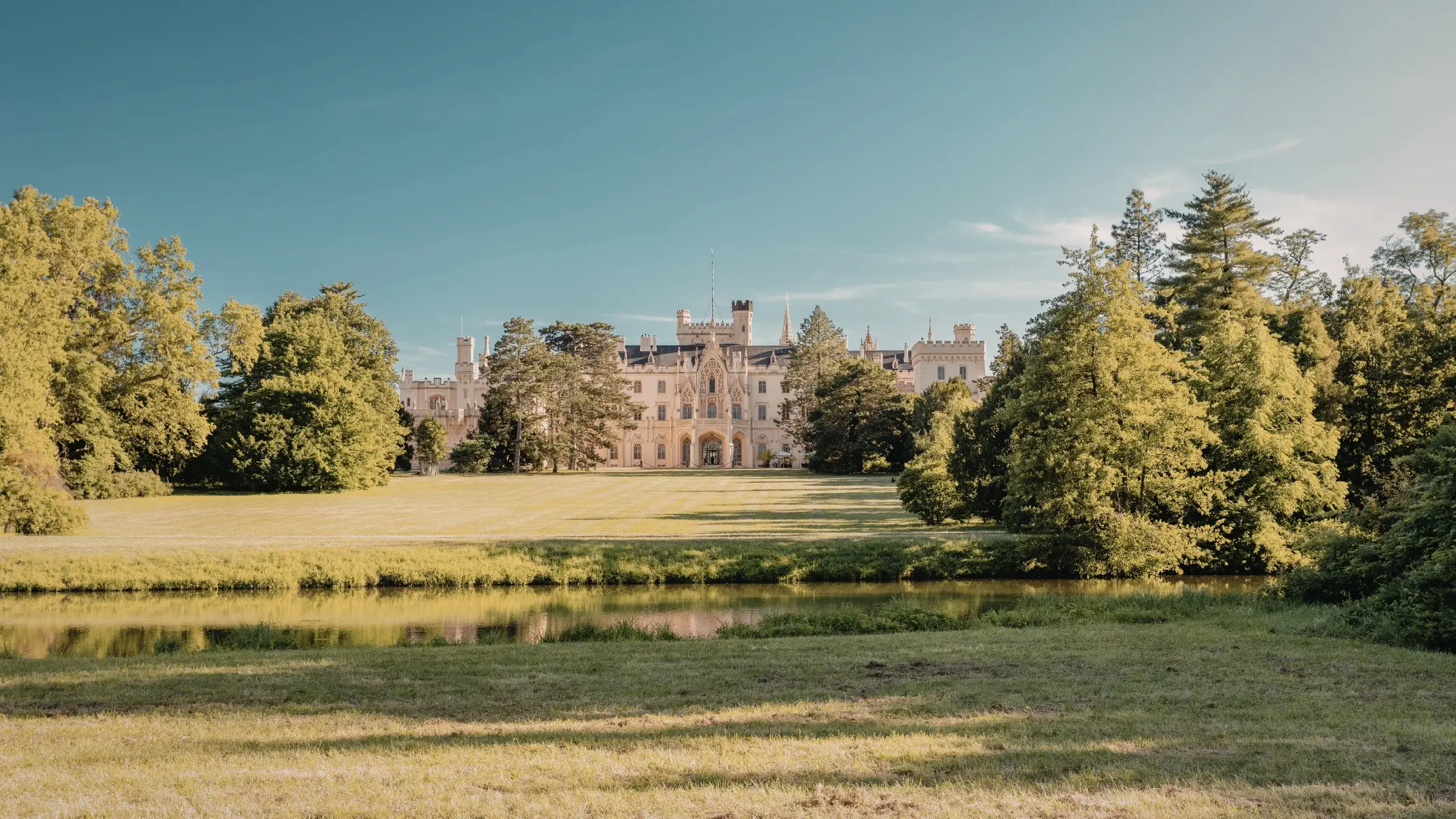Willowmere House exterior in late afternoon light, surrounded by formal gardens